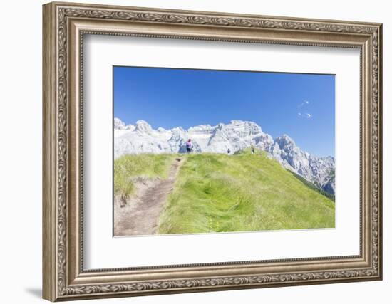 Hikers proceed on the path to the rocky peaks, Doss Del Sabion, Pinzolo, Brenta Dolomites, Trentino-Roberto Moiola-Framed Photographic Print