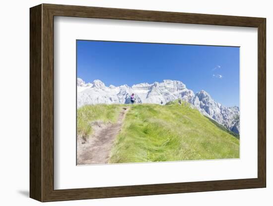 Hikers proceed on the path to the rocky peaks, Doss Del Sabion, Pinzolo, Brenta Dolomites, Trentino-Roberto Moiola-Framed Photographic Print