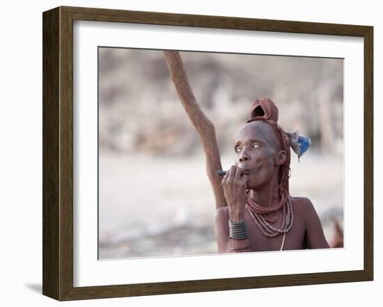 Himba Woman Smokes Outside Her Thatched Home in the Tiny Village, Purros, Namibia, Africa-Kim Walker-Framed Photographic Print