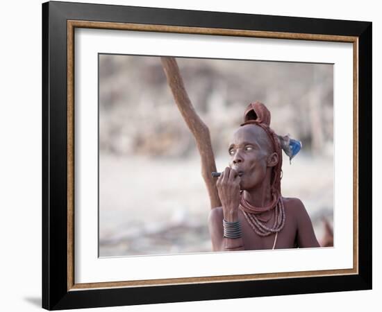 Himba Woman Smokes Outside Her Thatched Home in the Tiny Village, Purros, Namibia, Africa-Kim Walker-Framed Photographic Print