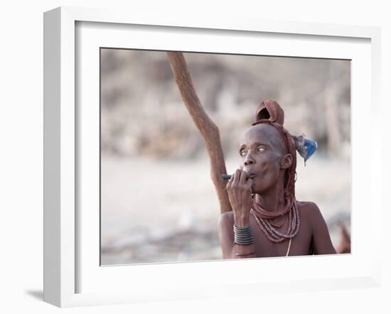 Himba Woman Smokes Outside Her Thatched Home in the Tiny Village, Purros, Namibia, Africa-Kim Walker-Framed Photographic Print