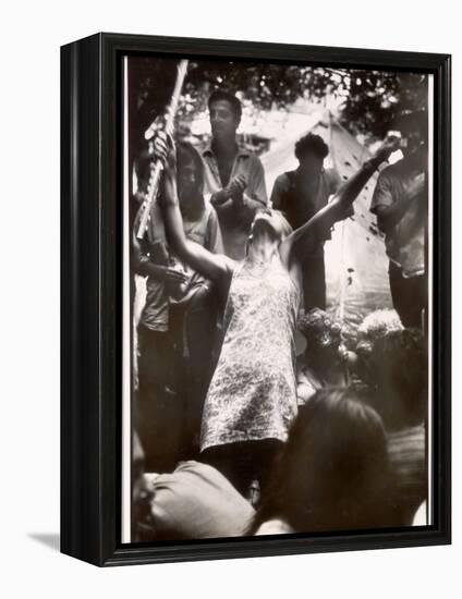 Hippie Girl Enthusiastically Playing Flute and Dancing at Woodstock Music Festival-null-Framed Premier Image Canvas