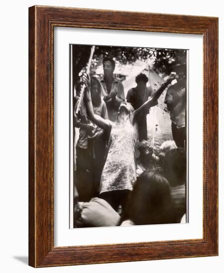 Hippie Girl Enthusiastically Playing Flute and Dancing at Woodstock Music Festival-null-Framed Photographic Print