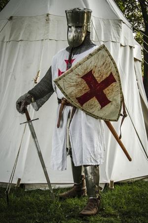 https://imgc.artprintimages.com/img/print/historical-reenactment-templar-knight-with-great-helm-sword-and-shield-13th-century_u-l-pv77f40.jpg?artPerspective=n