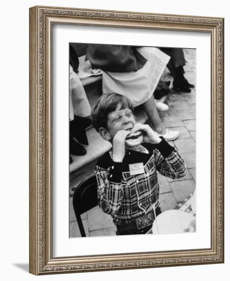 Hollywood Child Timmy Garry at Children's party Dressed in Cowboy Outfit eating a Hamburger-J^ R^ Eyerman-Framed Photographic Print