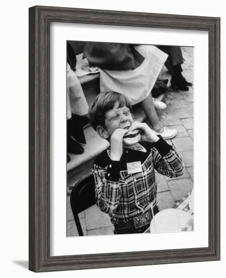 Hollywood Child Timmy Garry at Children's party Dressed in Cowboy Outfit eating a Hamburger-J^ R^ Eyerman-Framed Photographic Print