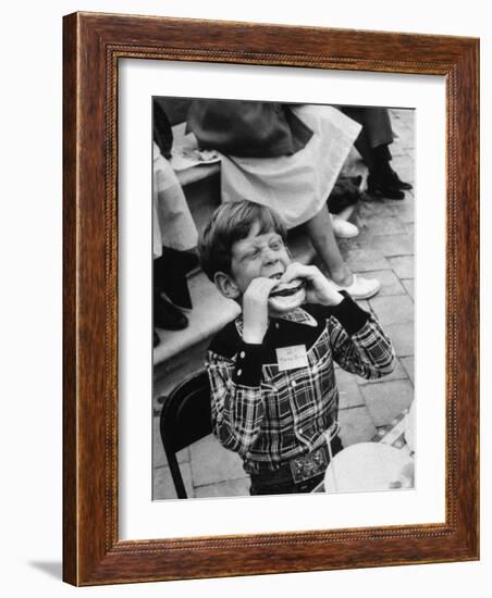 Hollywood Child Timmy Garry at Children's party Dressed in Cowboy Outfit eating a Hamburger-J^ R^ Eyerman-Framed Photographic Print