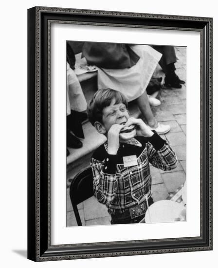 Hollywood Child Timmy Garry at Children's party Dressed in Cowboy Outfit eating a Hamburger-J^ R^ Eyerman-Framed Photographic Print