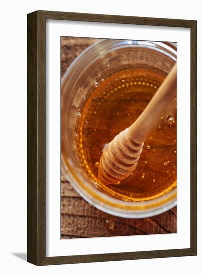 Honey Spoon In A Glass Jar Of Honey-Shea Evans-Framed Photographic Print