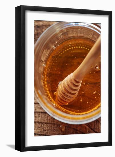 Honey Spoon In A Glass Jar Of Honey-Shea Evans-Framed Photographic Print