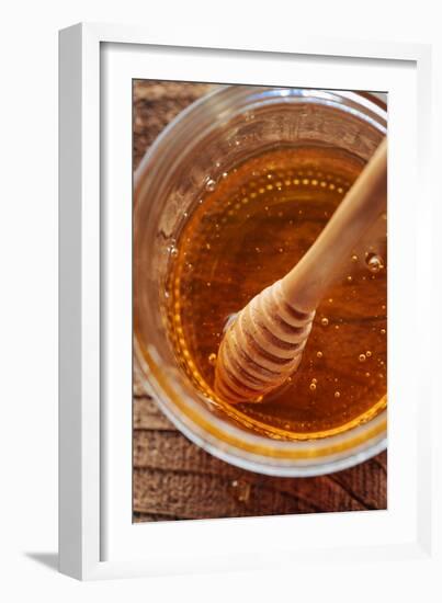 Honey Spoon In A Glass Jar Of Honey-Shea Evans-Framed Photographic Print