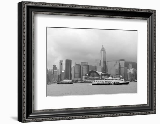 Hong Kong Skyline with Boats in Victoria Harbor in Black and White.-Songquan Deng-Framed Photographic Print