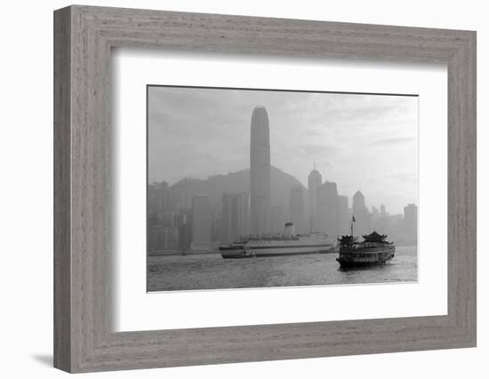 Hong Kong Skyline with Boats in Victoria Harbor in Black and White.-Songquan Deng-Framed Photographic Print