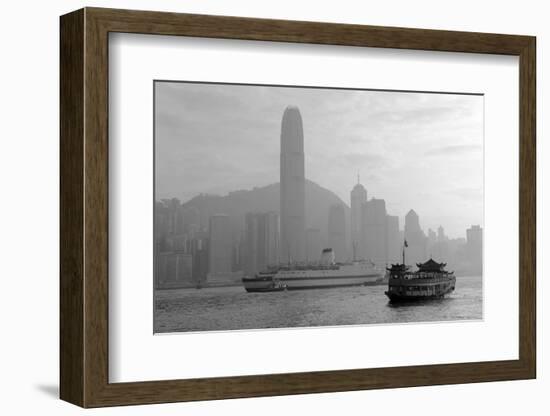 Hong Kong Skyline with Boats in Victoria Harbor in Black and White.-Songquan Deng-Framed Photographic Print