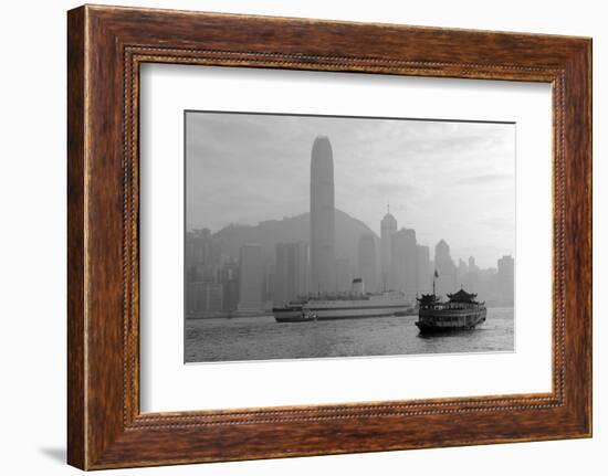 Hong Kong Skyline with Boats in Victoria Harbor in Black and White.-Songquan Deng-Framed Photographic Print