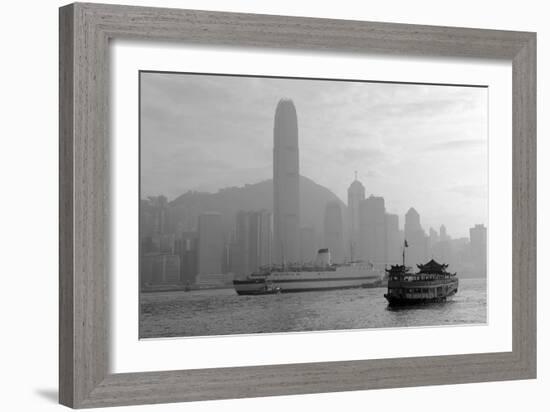 Hong Kong Skyline with Boats in Victoria Harbor in Black and White.-Songquan Deng-Framed Photographic Print