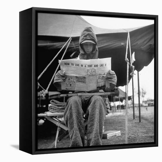 Hooded Recruit Wearing Oddly Assorted Clothing Issue and Reading Copy of the Base Newspaper-Loomis Dean-Framed Premier Image Canvas