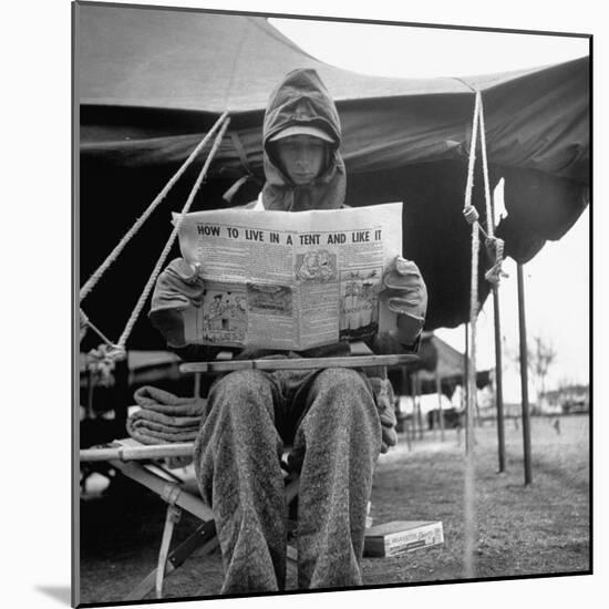 Hooded Recruit Wearing Oddly Assorted Clothing Issue and Reading Copy of the Base Newspaper-Loomis Dean-Mounted Photographic Print