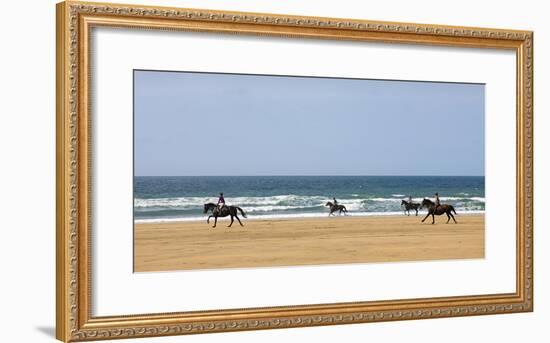 Horse rider's galloping down sandy Cornish beach on a summer's day, Sandymouth, Cornwall, England. -Adam Burton-Framed Photographic Print