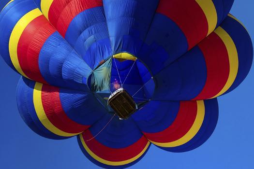 Hot air balloon brings color to the sky print by Larry Ditto