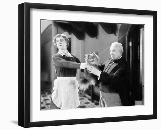 Housekeeper is Pushing a Puppy Away-null-Framed Photo