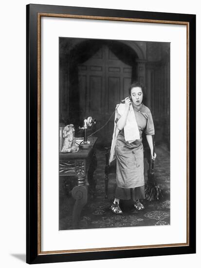 Housekeeper Looking Disheveled Listening on the Telephone-null-Framed Photo