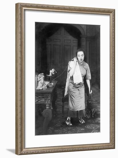 Housekeeper Looking Disheveled Listening on the Telephone-null-Framed Photo