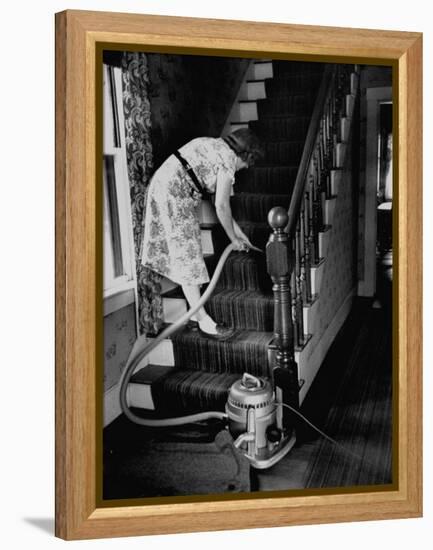 Housewife Cleaning Her Carpet with Vacuum Cleaners-Yale Joel-Framed Premier Image Canvas