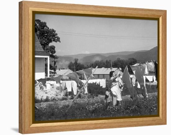 Housewife in Tygart Valley Removing Laundry from Clothesline, Her Young Daughter Stands Beside Her-Carl Mydans-Framed Premier Image Canvas