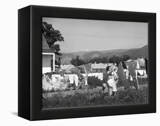 Housewife in Tygart Valley Removing Laundry from Clothesline, Her Young Daughter Stands Beside Her-Carl Mydans-Framed Premier Image Canvas