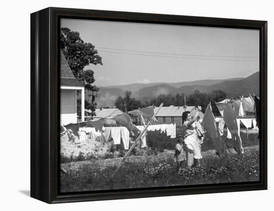 Housewife in Tygart Valley Removing Laundry from Clothesline, Her Young Daughter Stands Beside Her-Carl Mydans-Framed Premier Image Canvas