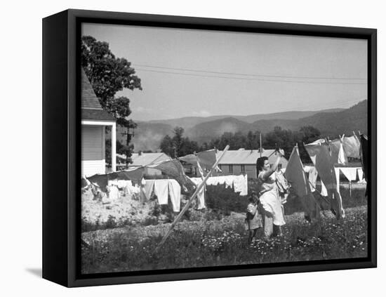 Housewife in Tygart Valley Removing Laundry from Clothesline, Her Young Daughter Stands Beside Her-Carl Mydans-Framed Premier Image Canvas