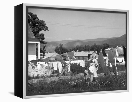 Housewife in Tygart Valley Removing Laundry from Clothesline, Her Young Daughter Stands Beside Her-Carl Mydans-Framed Premier Image Canvas
