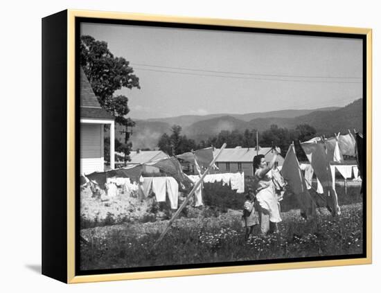 Housewife in Tygart Valley Removing Laundry from Clothesline, Her Young Daughter Stands Beside Her-Carl Mydans-Framed Premier Image Canvas