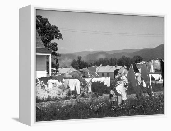 Housewife in Tygart Valley Removing Laundry from Clothesline, Her Young Daughter Stands Beside Her-Carl Mydans-Framed Premier Image Canvas