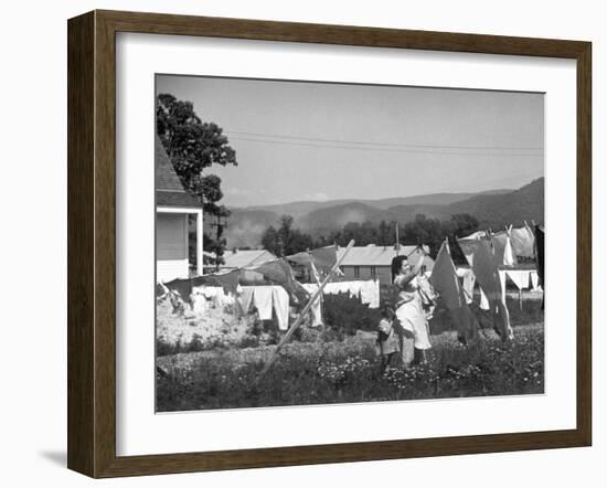 Housewife in Tygart Valley Removing Laundry from Clothesline, Her Young Daughter Stands Beside Her-Carl Mydans-Framed Photographic Print