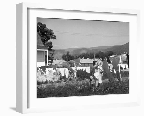 Housewife in Tygart Valley Removing Laundry from Clothesline, Her Young Daughter Stands Beside Her-Carl Mydans-Framed Photographic Print