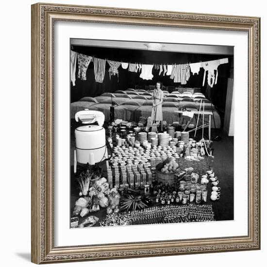 Housewife Marjorie McWeeney with Broom Amidst Display of Her Week's Housework, Bloomingdale's Store-Nina Leen-Framed Photographic Print