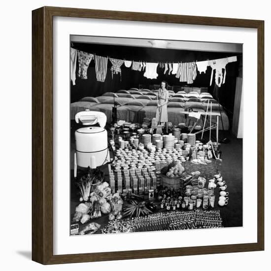 Housewife Marjorie McWeeney with Broom Amidst Display of Her Week's Housework, Bloomingdale's Store-Nina Leen-Framed Photographic Print