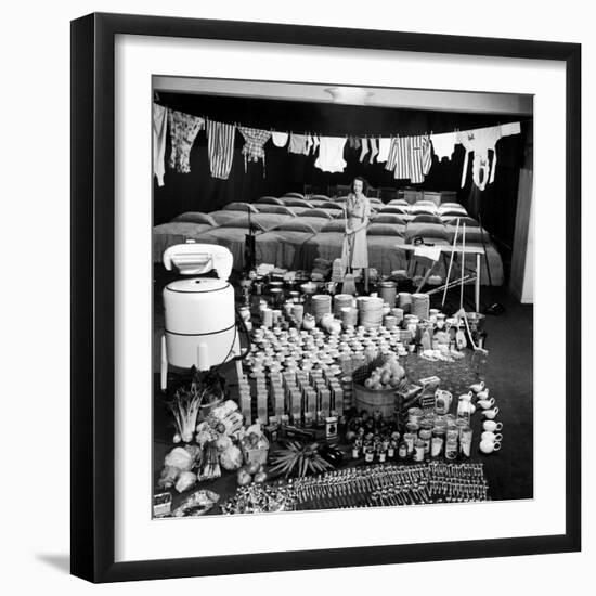 Housewife Marjorie McWeeney with Broom Amidst Display of Her Week's Housework, Bloomingdale's Store-Nina Leen-Framed Photographic Print