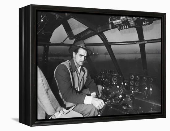 Howard Hughes Sitting at the Controls of His 200 Ton Flying Boat Called the "Spruce Goose"-J^ R^ Eyerman-Framed Premier Image Canvas