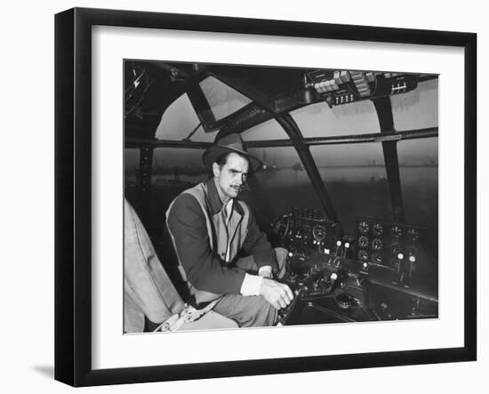 Howard Hughes Sitting at the Controls of His 200 Ton Flying Boat Called the "Spruce Goose"-J^ R^ Eyerman-Framed Premium Photographic Print