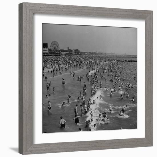 Huge Crowd Gathered in the Surf and at the Beach in Front of Coney Island Amusement Park-Marie Hansen-Framed Photographic Print