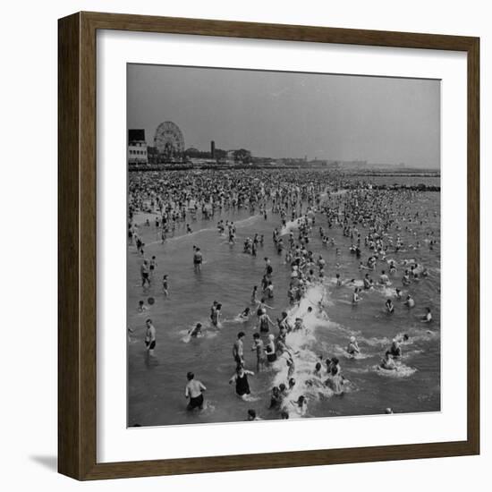 Huge Crowd Gathered in the Surf and at the Beach in Front of Coney Island Amusement Park-Marie Hansen-Framed Photographic Print