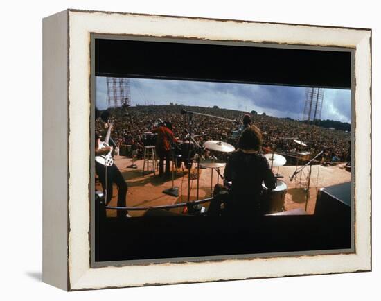 Huge Crowd Listening to a Band Onstage at the Woodstock Music and Art Festival-Bill Eppridge-Framed Premier Image Canvas