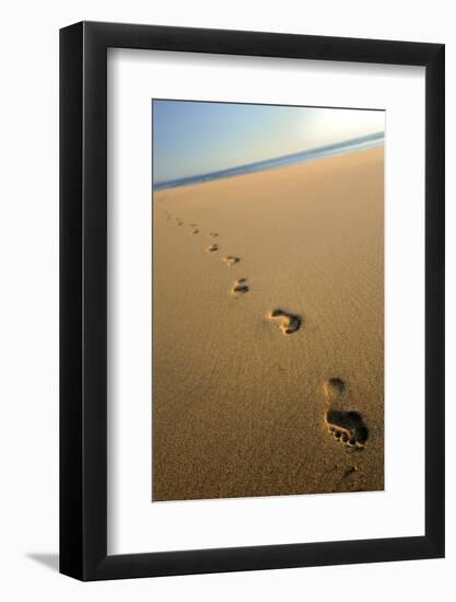 Human footprints in the sand, Sandymouth bay, Cornwall, UK-Ross Hoddinott-Framed Photographic Print