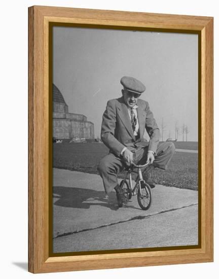 Humorous of Man Riding Tiny Bicycle-Wallace Kirkland-Framed Premier Image Canvas