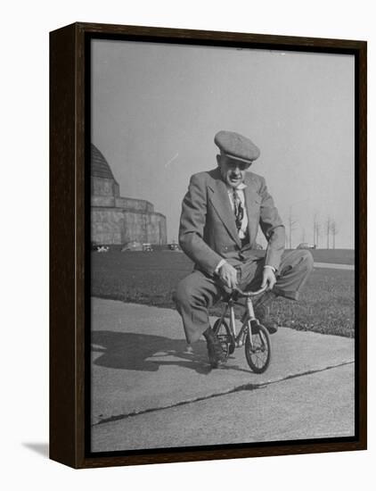 Humorous of Man Riding Tiny Bicycle-Wallace Kirkland-Framed Premier Image Canvas