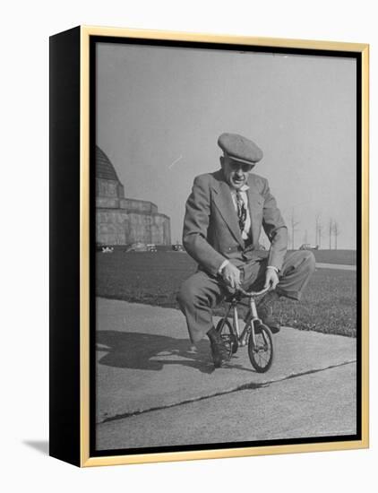 Humorous of Man Riding Tiny Bicycle-Wallace Kirkland-Framed Premier Image Canvas