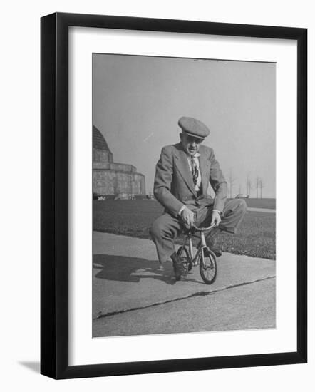 Humorous of Man Riding Tiny Bicycle-Wallace Kirkland-Framed Photographic Print